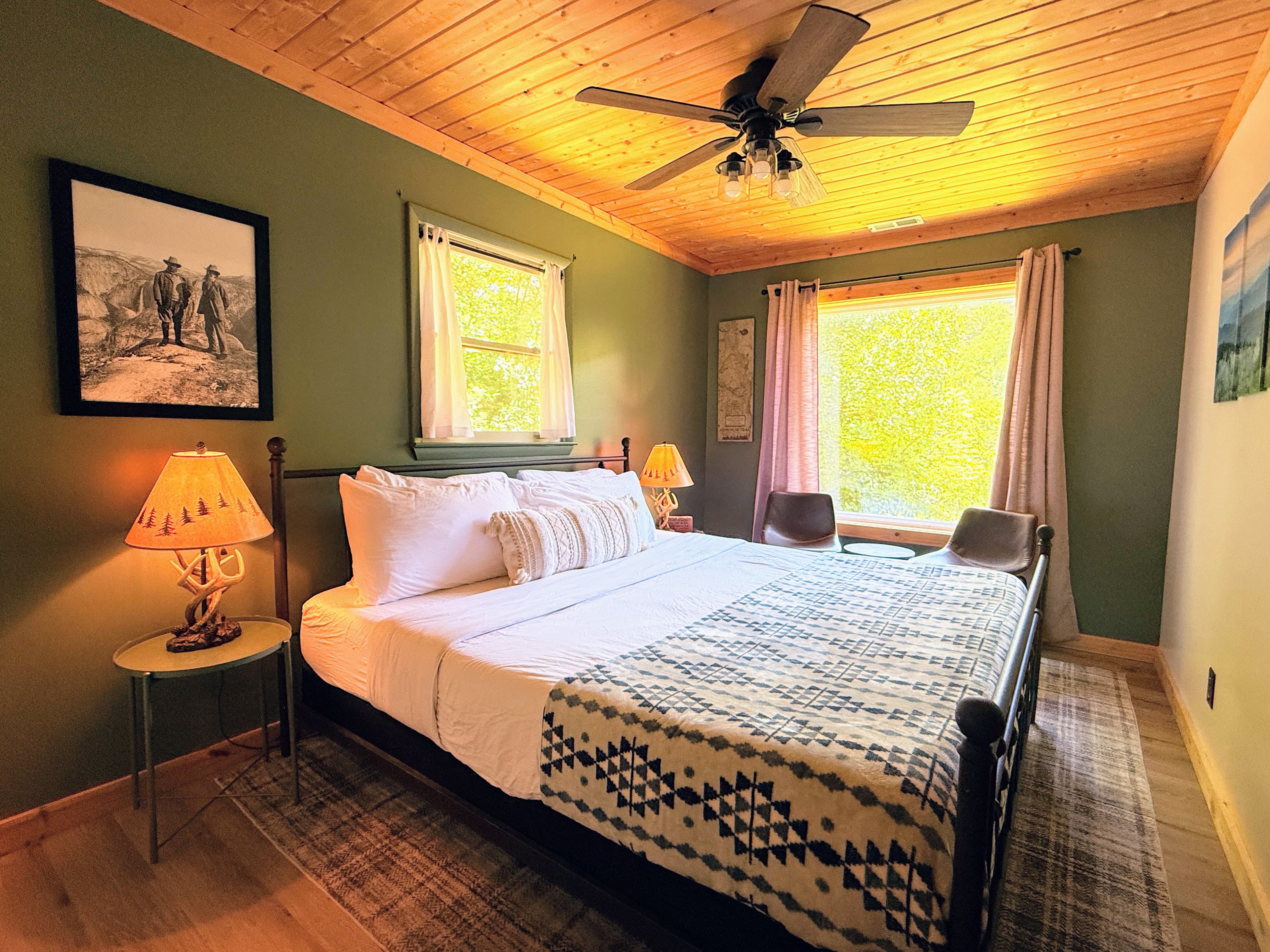 Secondary Guest bedroom with a king-sized log bed, luxury linens, themed to honor John Muir and picture window with mountain view