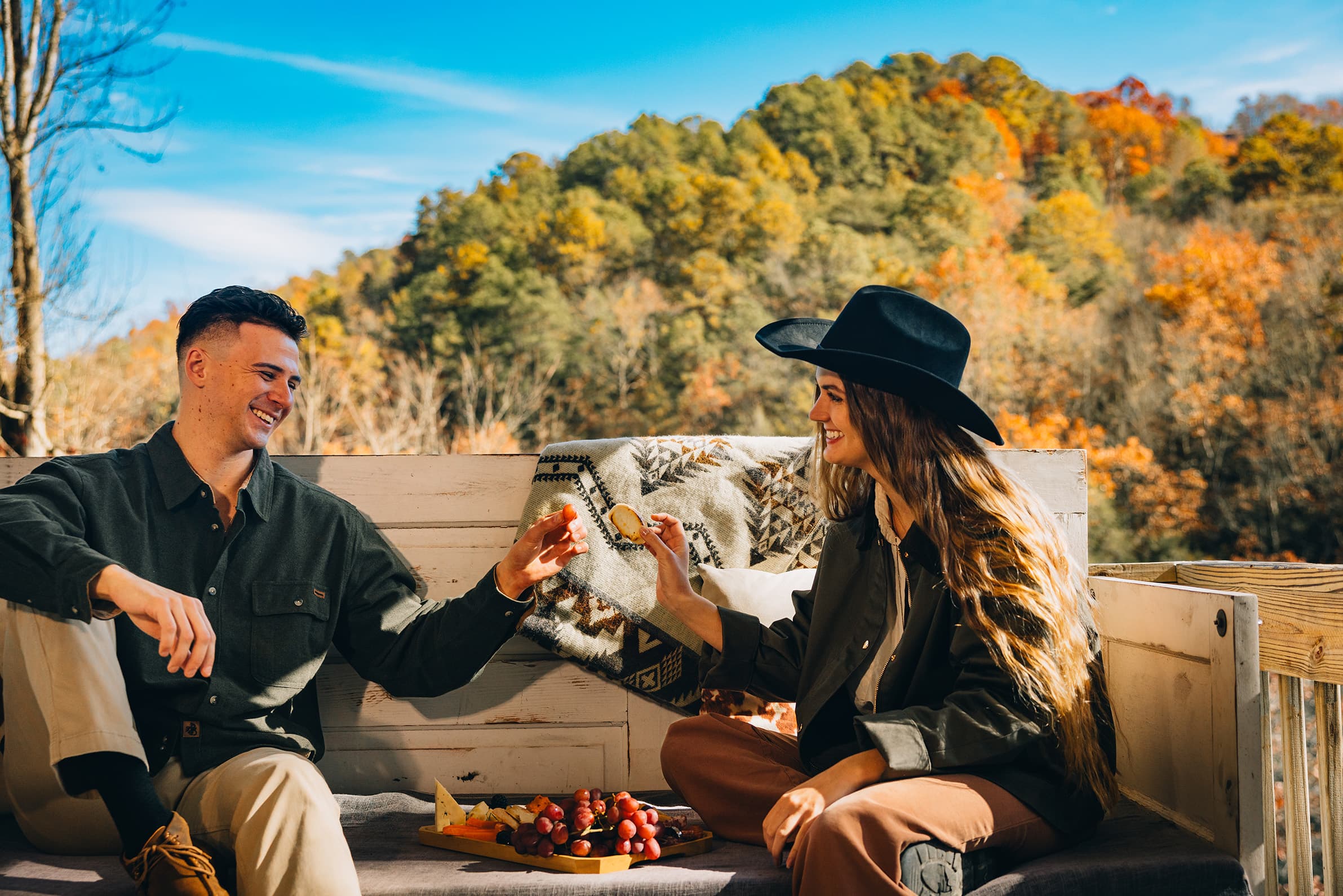 Large covered balcony at Livingstone Great House featuring luxury outdoor seating and an unobstructed panoramic view of the Smoky Mountain ridgeline.