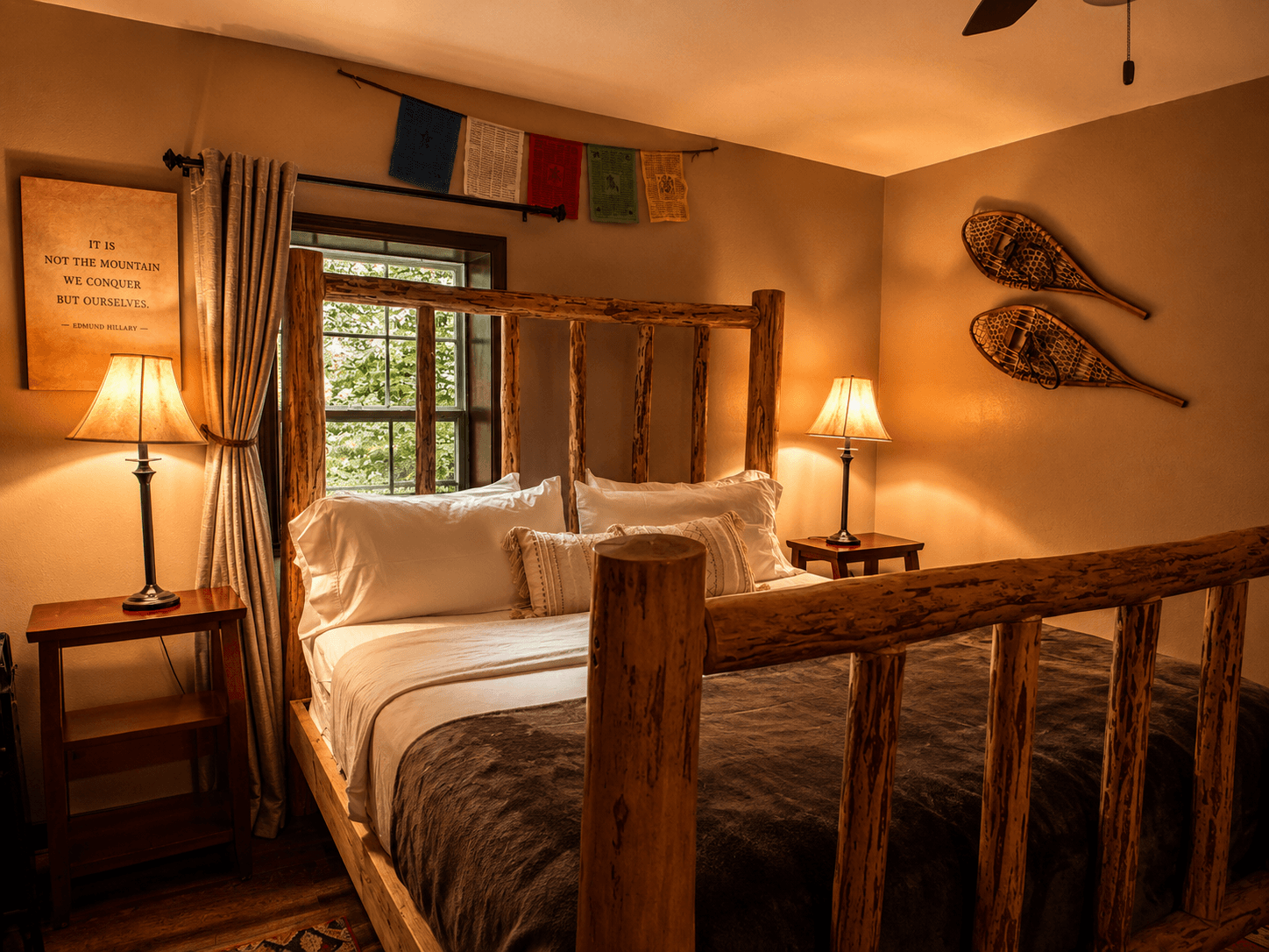 Family Suite: 3 of 3 rooms themed for Everest explorers featuring King bed with Rustic log bed guest bedroom at Livingstone Station Lodge inspired by classic wilderness expeditions in Bryson City, North Carolina.
