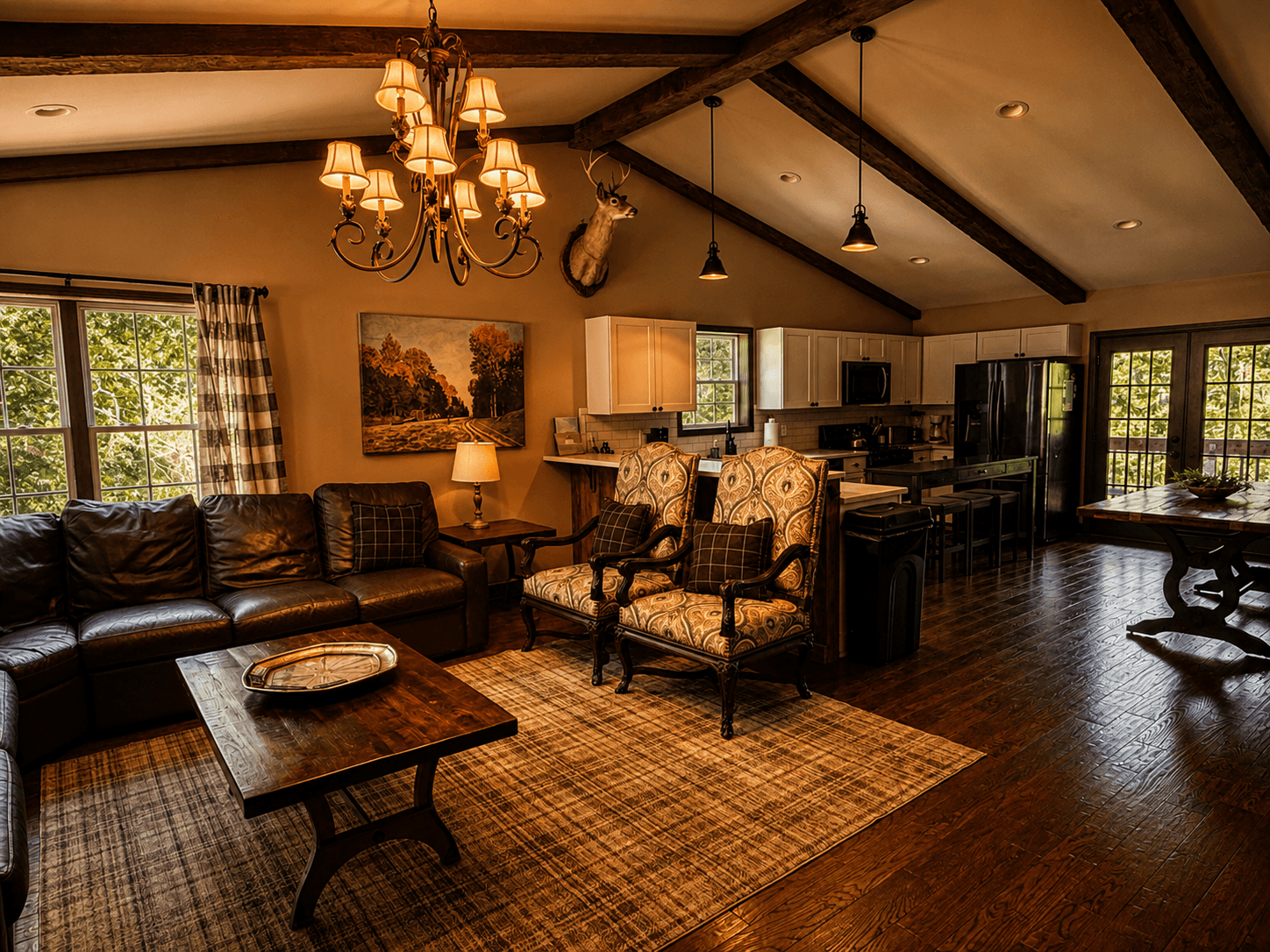 .Spacious great room with vaulted ceilings, gourmet kitchen and mountain lodge furnishings at Livingstone Station Lodge at Three Little Bears Retreat in Bryson City, North Carolina.