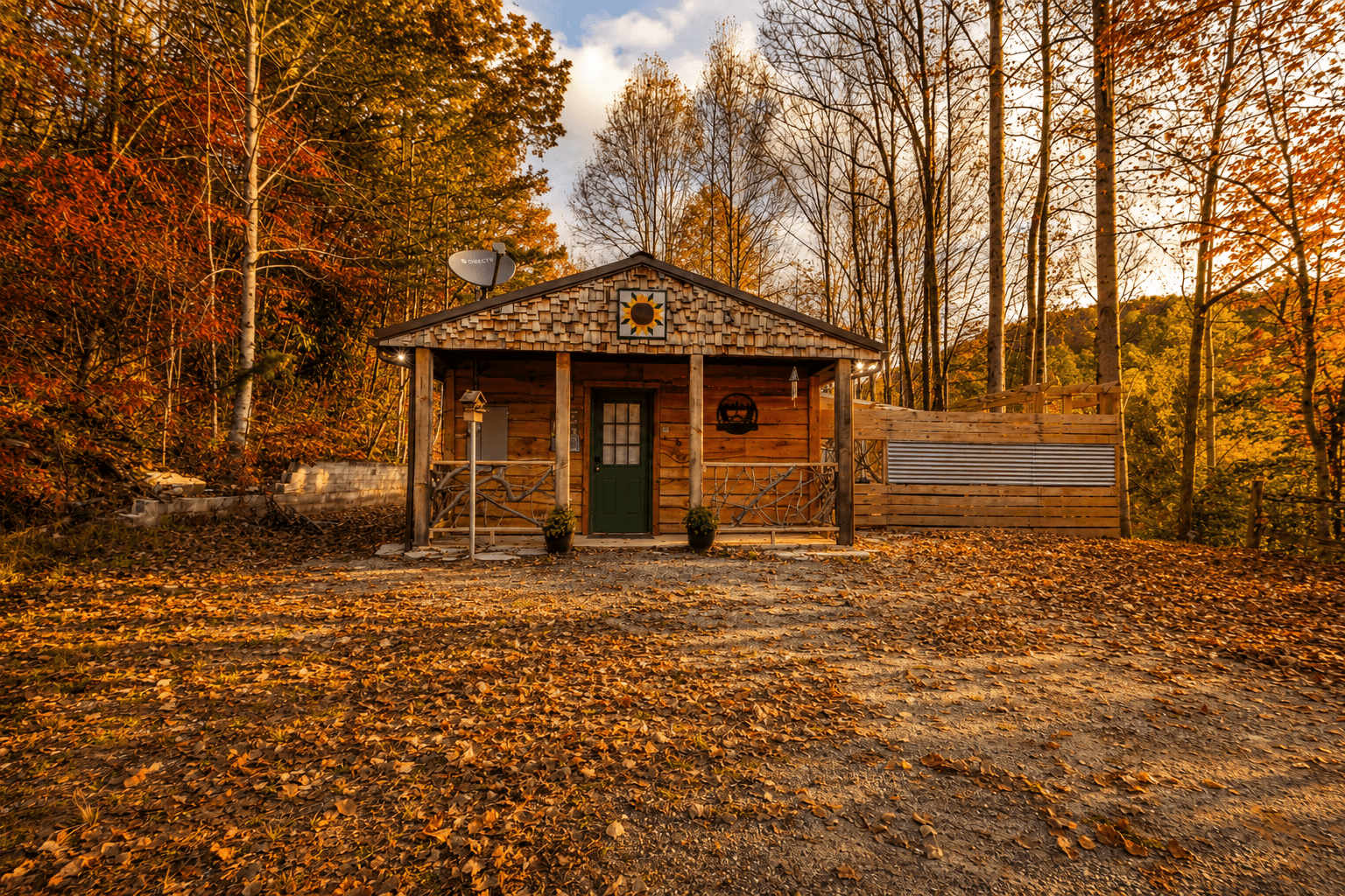 A cozy wooden cabin surrounded by autumn foliage.