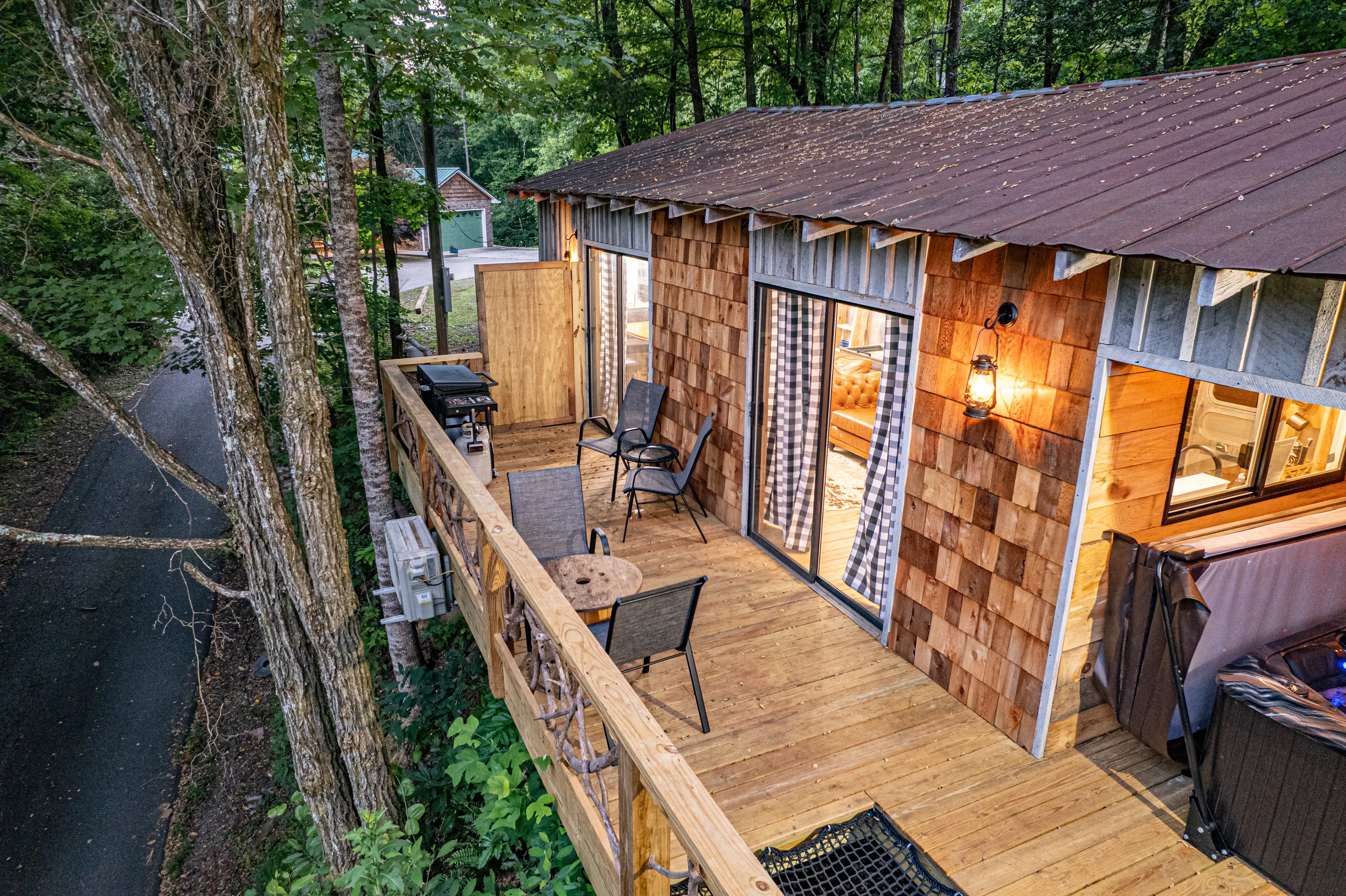 view of cantilevered deck high in trees for treehouse feeling